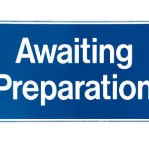 White text awaiting preparation printed on blue